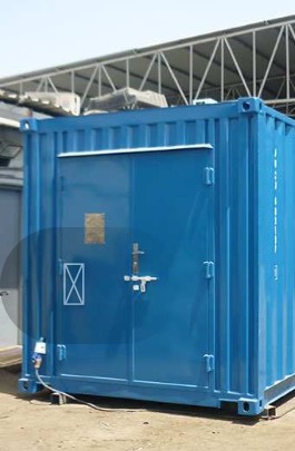 Blue container being fabricated beside a forklift